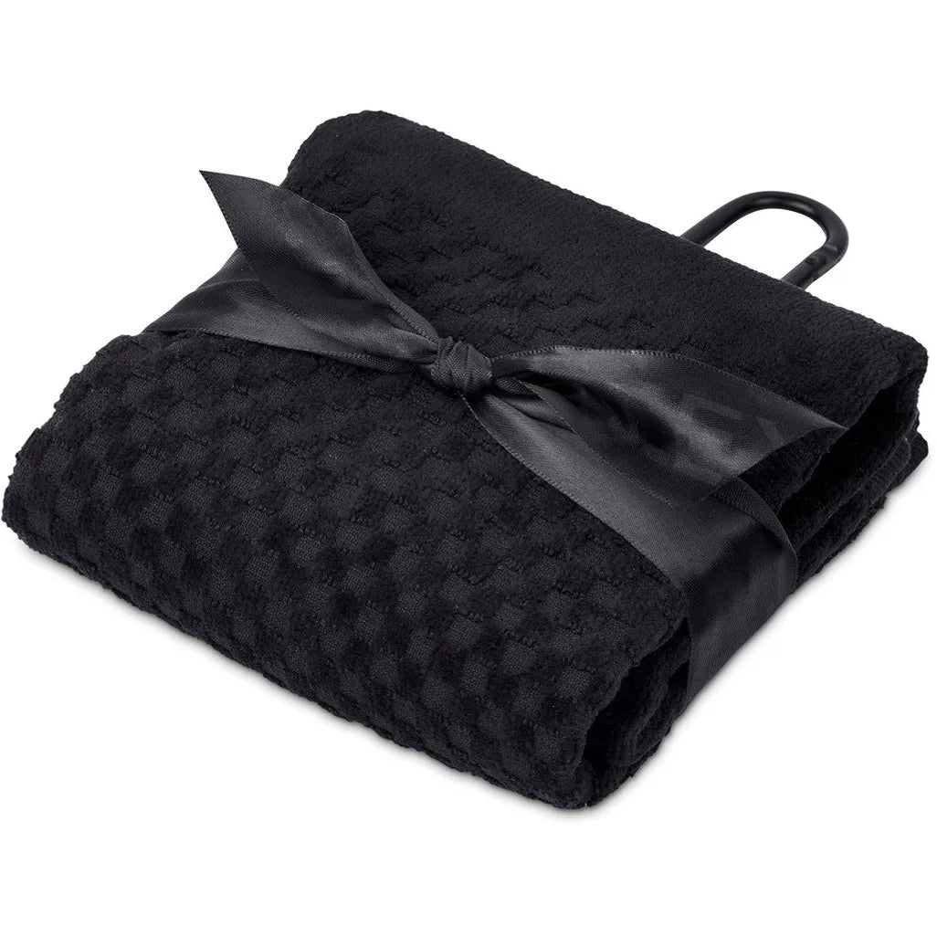 Folded black textured blanket with a satin ribbon on a white background