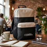 Backpack with 'Creative Commons' logo on a table in a cafe setting