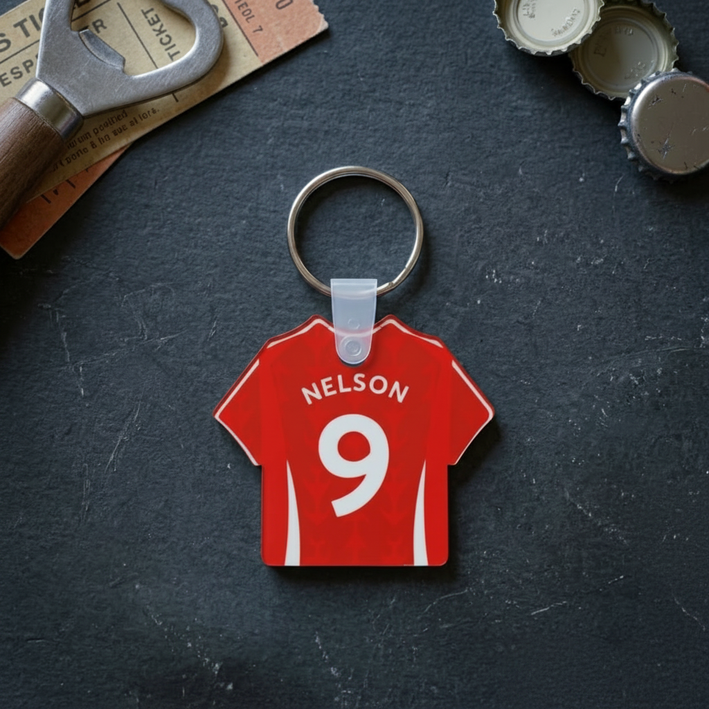 Red jersey keychain with 'Nelson' and number '9' on a dark surface with bottle opener and caps.