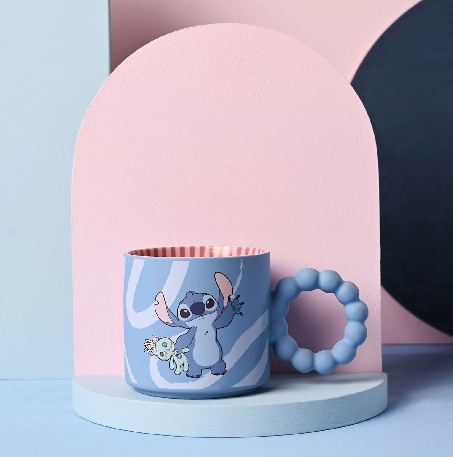 Children's mug with cartoon character and matching teether on a colorful background