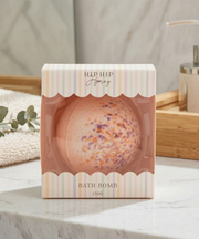 Bath bomb in packaging on a marble surface with a blurred background