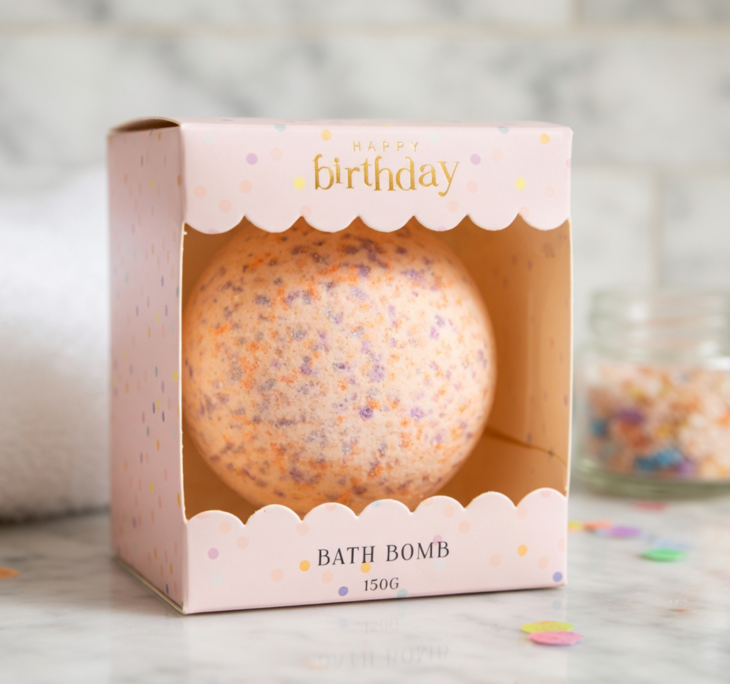 Bath bomb in a 'Happy Birthday' box on a light background
