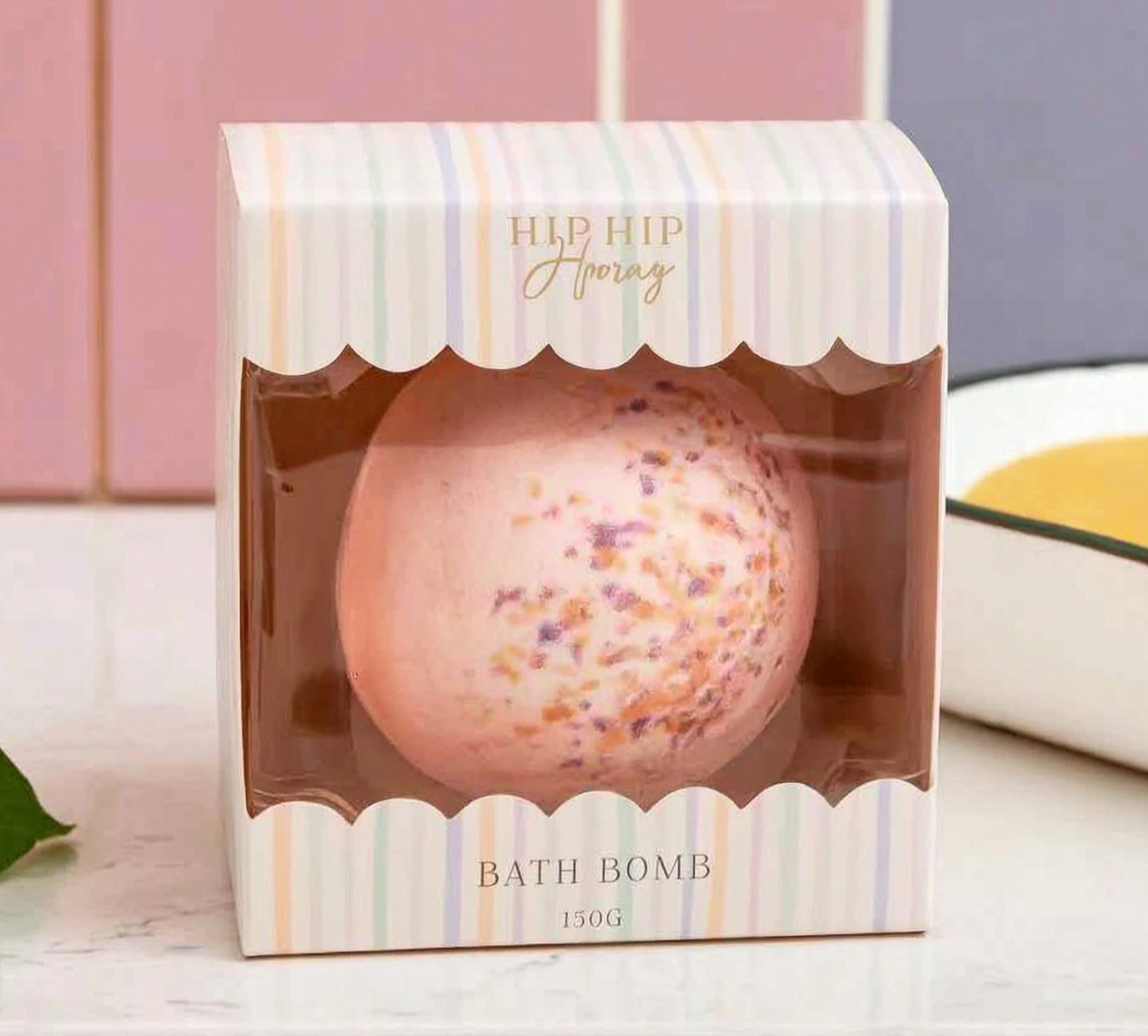 Bath bomb in a decorative box with 'HIP HIP Hooray' branding on a light background.