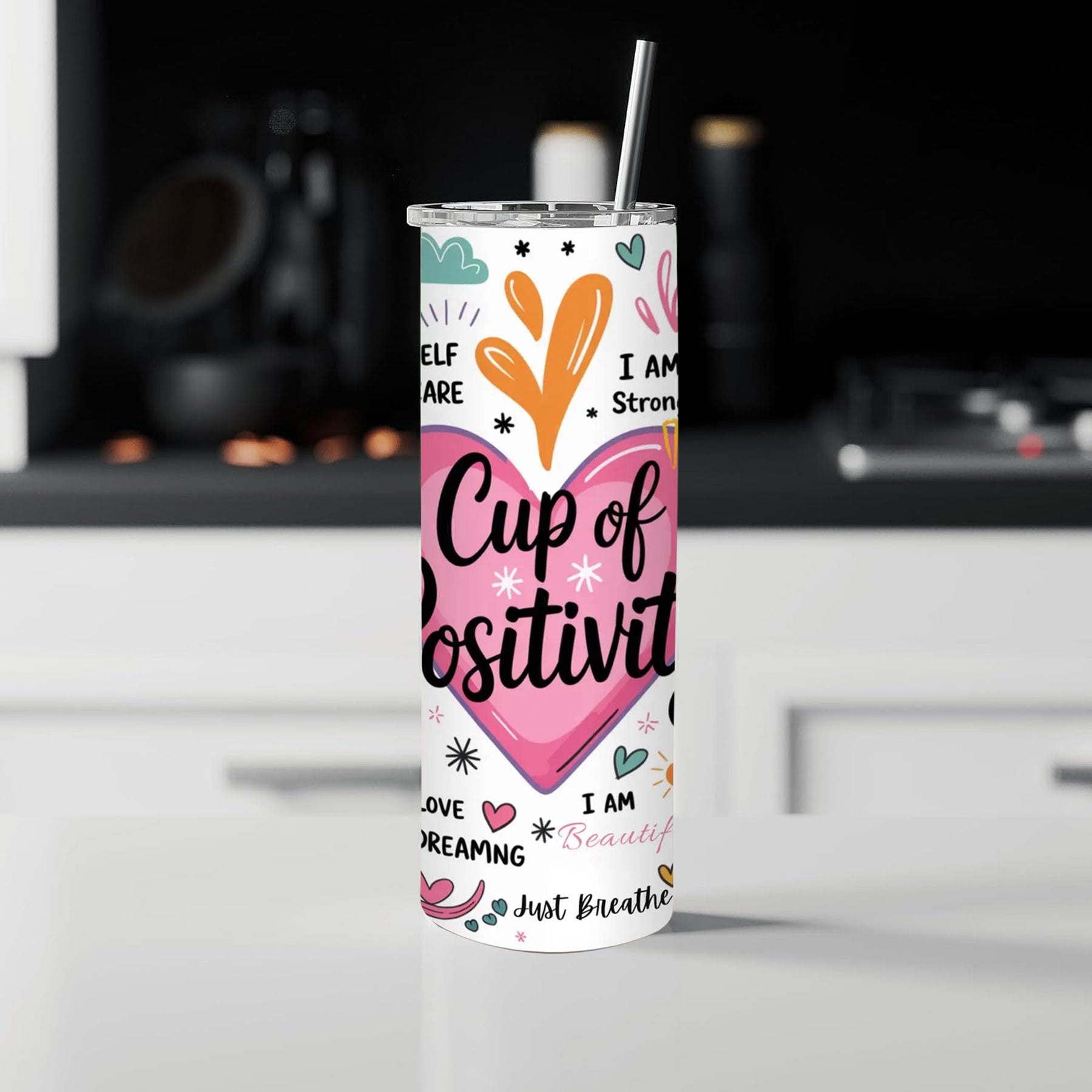 Tumbler with motivational quote and colorful design on a kitchen counter.