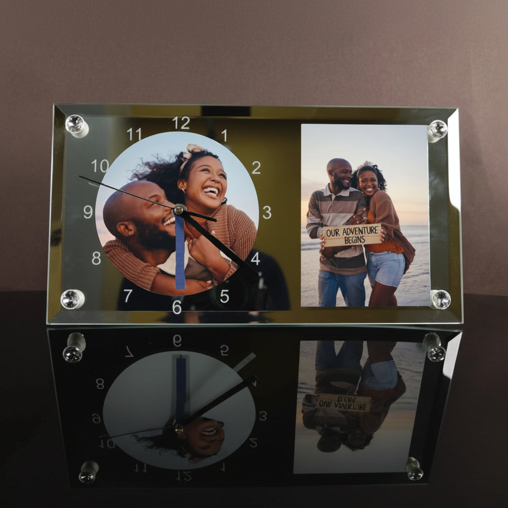 Glass clock with two photo frames showing a couple, one on each side, on a reflective surface.
