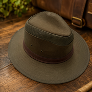 Brown hat with a leather band on a wooden surface