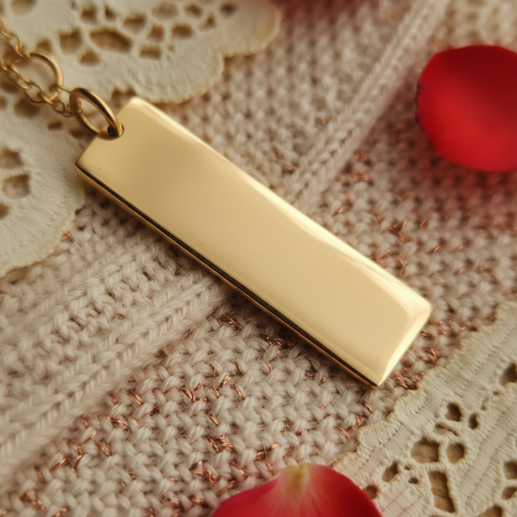 Gold pendant with engraved message on a textured fabric background
