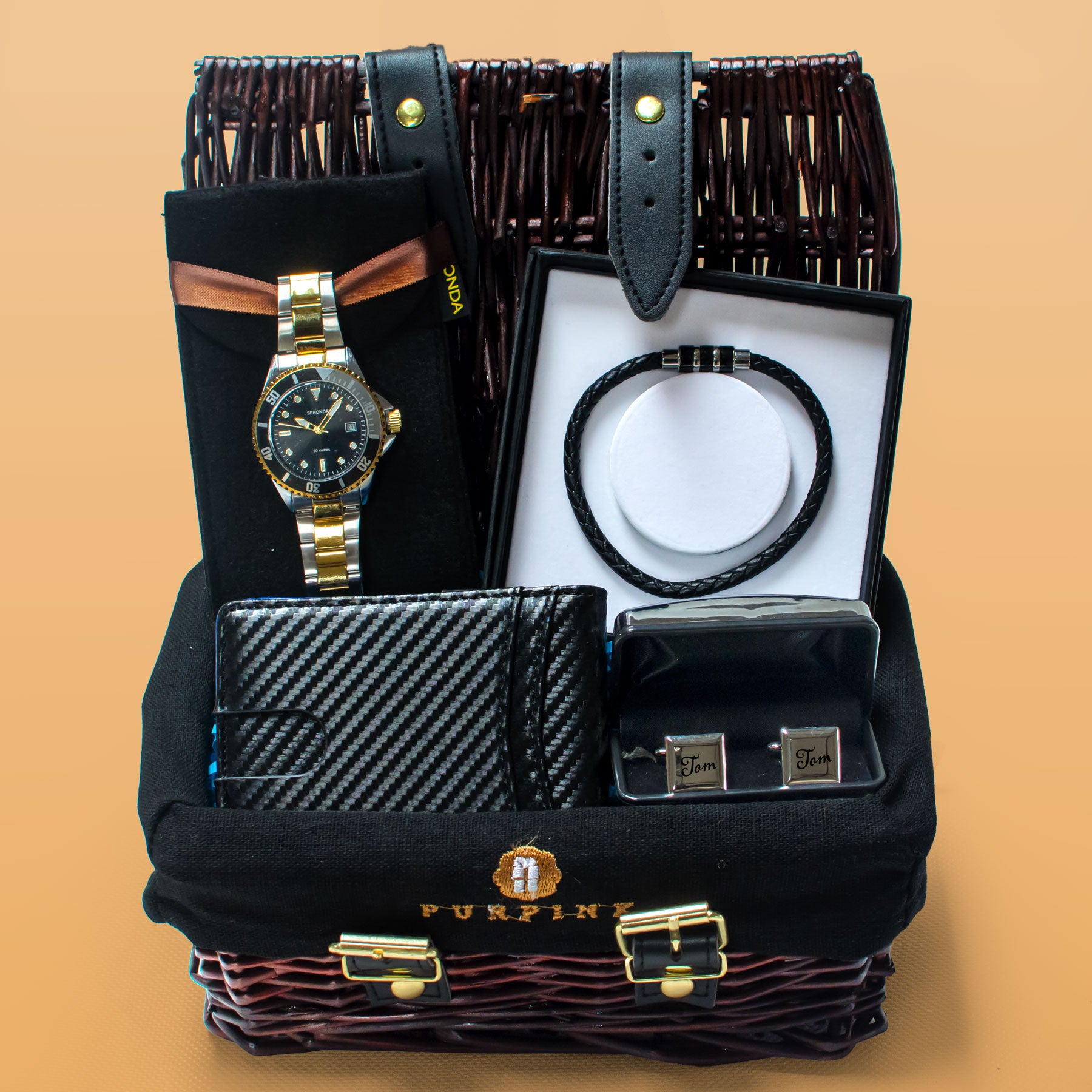 Groomsmen gift set with watches, wallets, and a bow tie in a black basket on a beige background.
