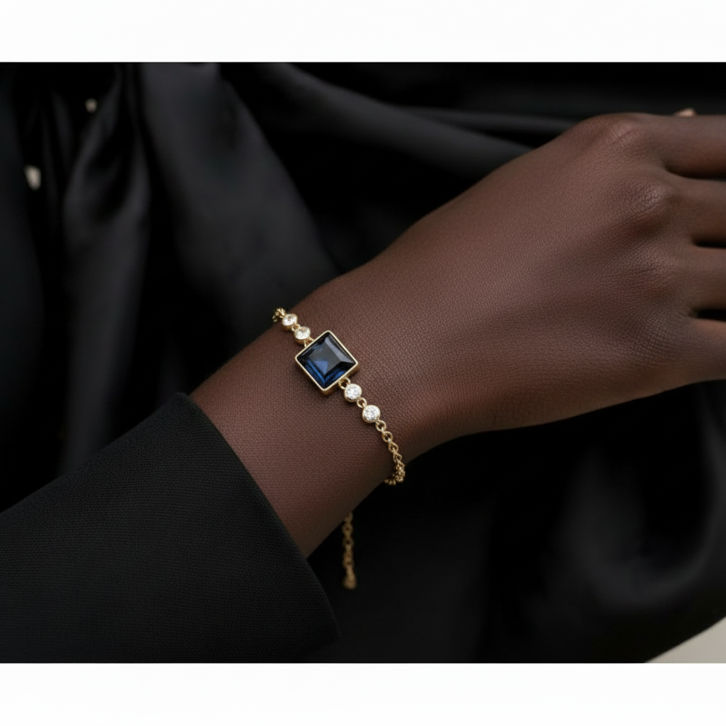 Bracelet with a blue gemstone on a dark fabric background