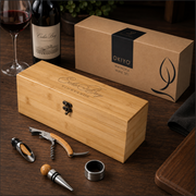 Wine set with wooden box, wine bottle, and accessories on a wooden surface.