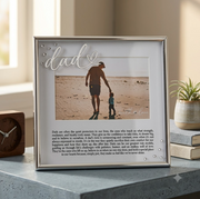Framed photo of a man and child on a beach with 'dad' text above.