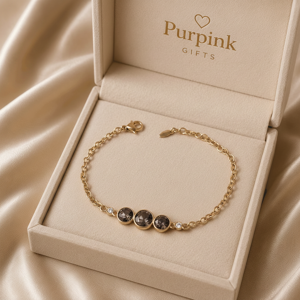 Gold bracelet with gemstones in a 'Purpink Gifts' box on beige fabric