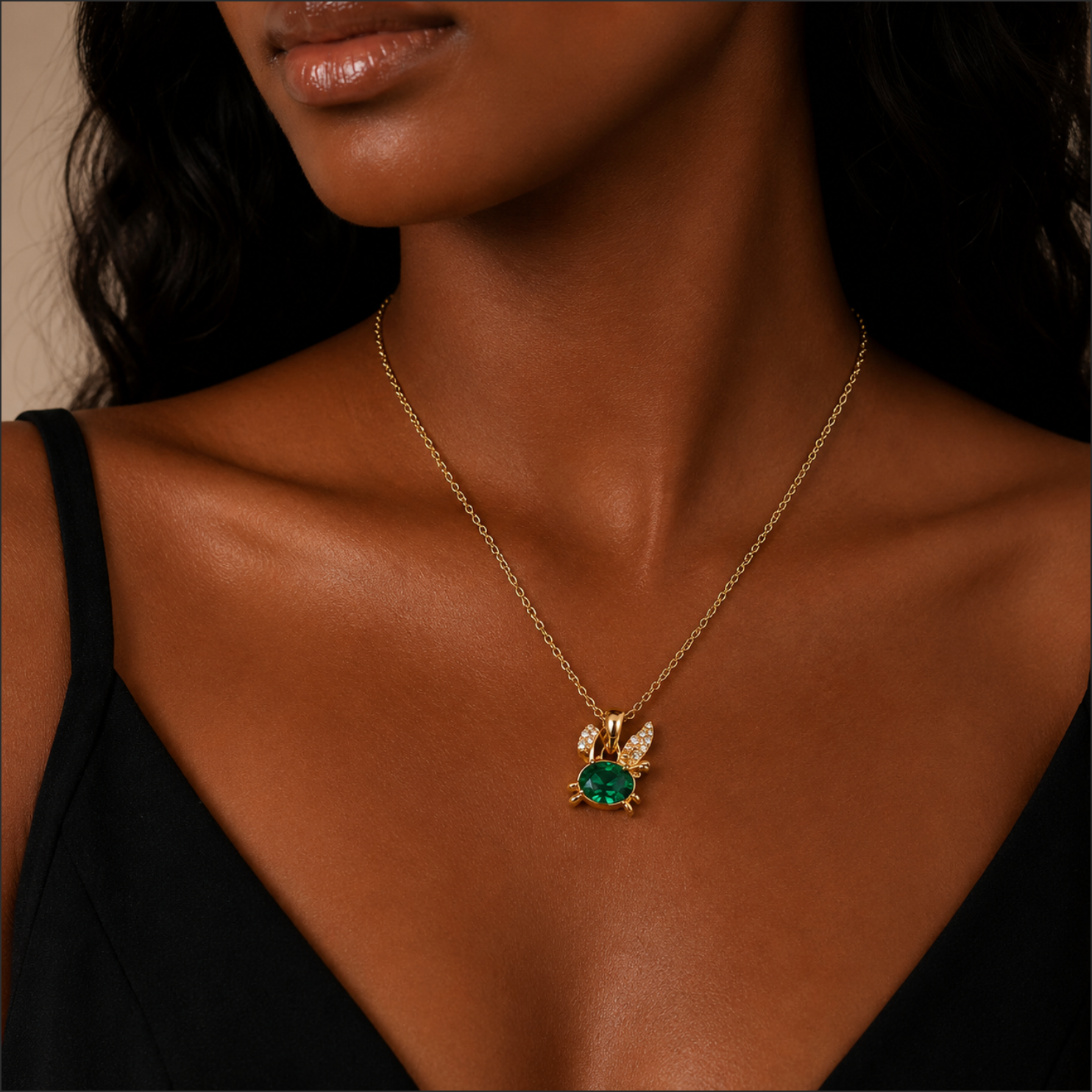 Gold necklace with a green gemstone pendant on a model