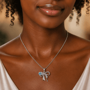 Woman wearing a silver necklace with a bow pendant