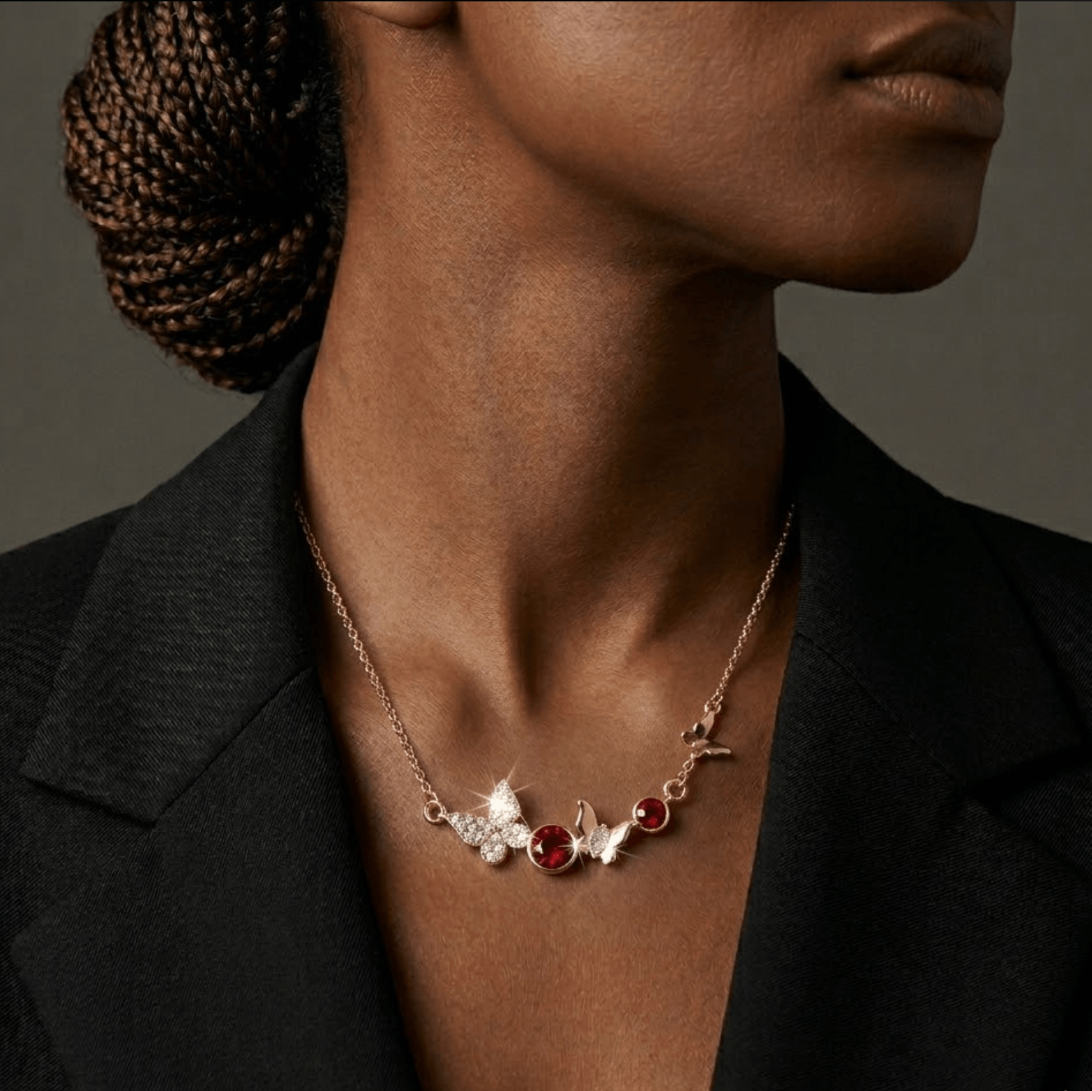 Necklace with red and white stones worn by a person against a neutral background
