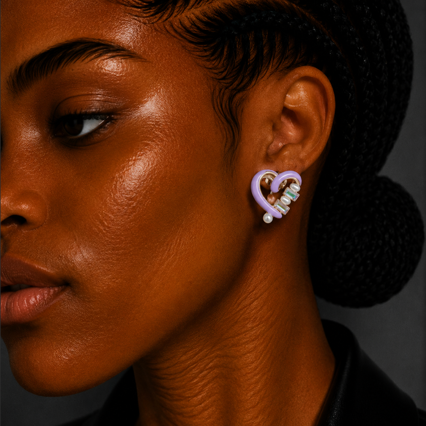 Close-up of a person wearing a unique earring with a dark background