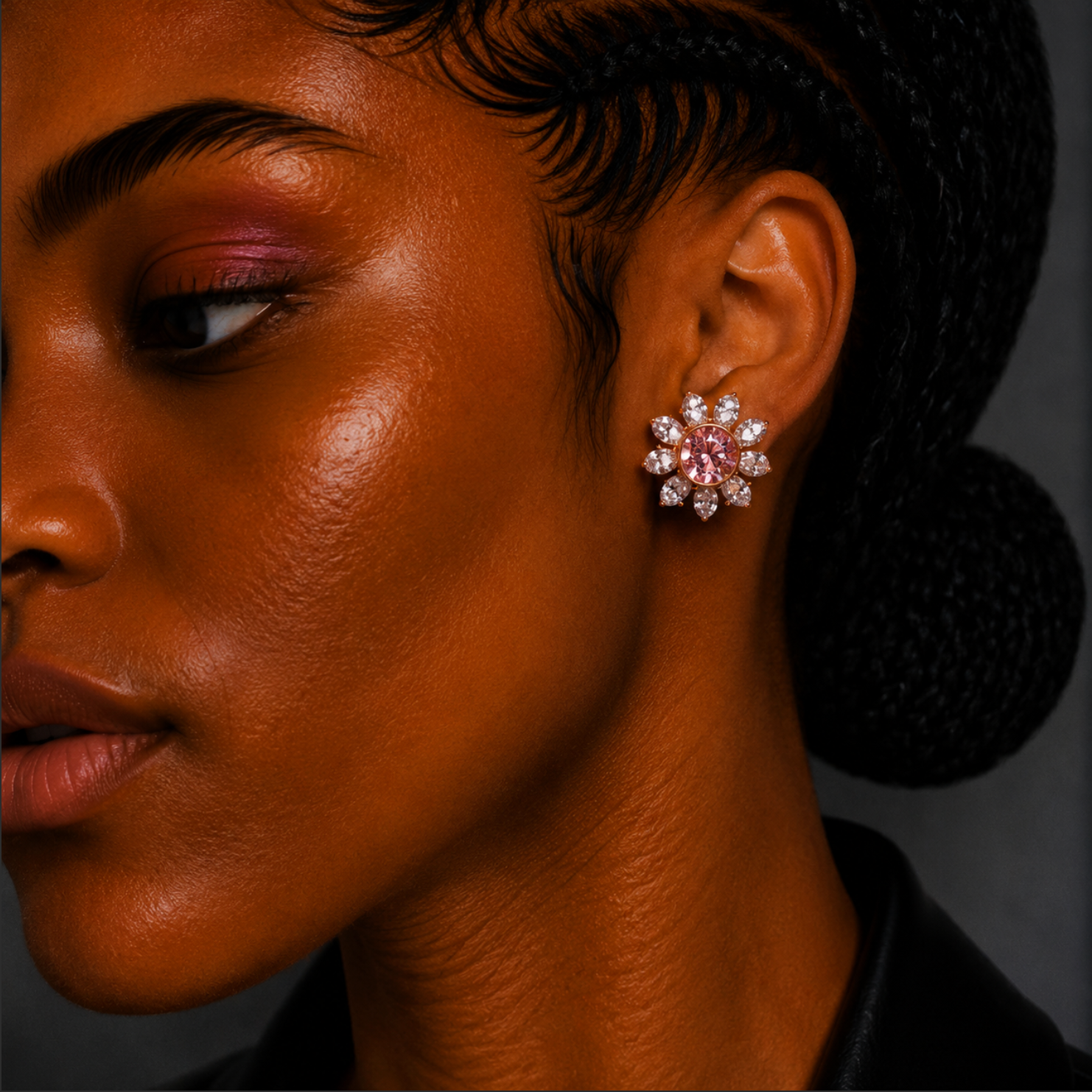 Close-up of a woman wearing a sparkling earring with a dark background