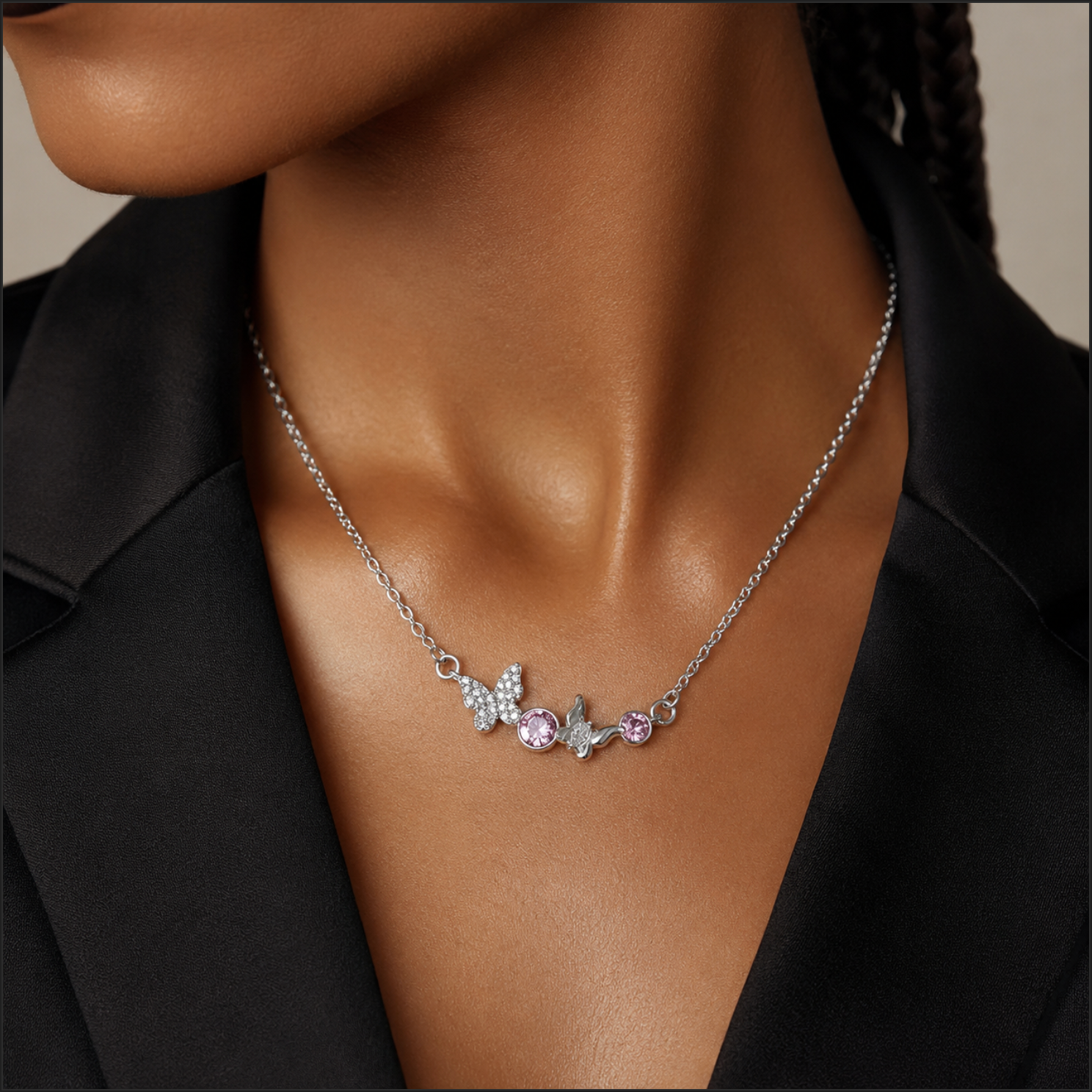 Necklace with pink gemstones worn by a person against a neutral background