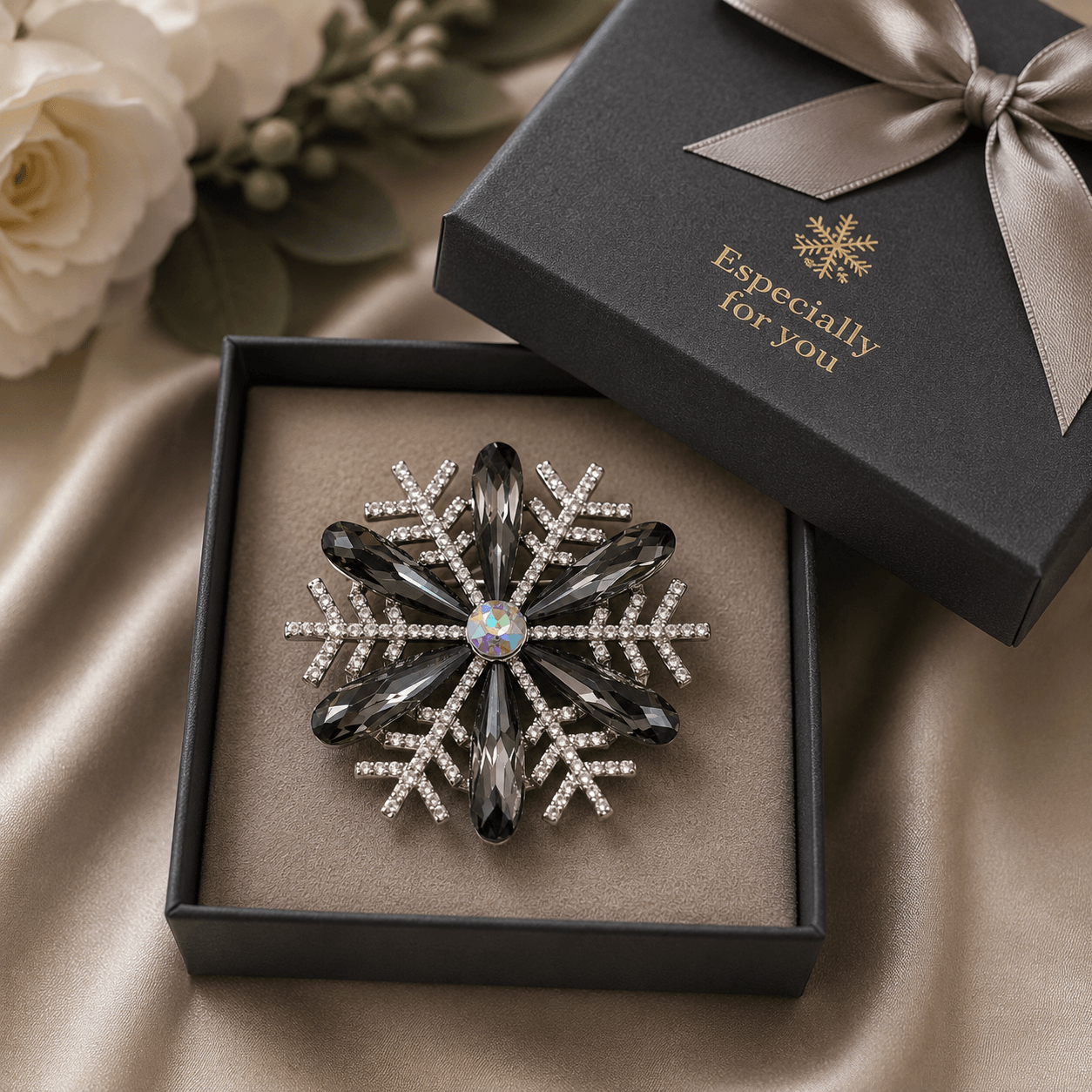 Snowflake-shaped jewelry in a gift box with flowers in the background