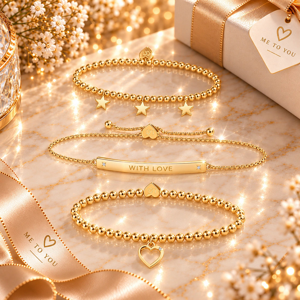 Three gold bracelets with heart charms in gift box